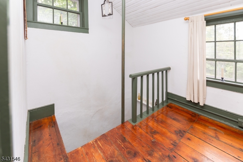 490 Mine Road Asbury, NJ 08802 - Photo 31 of 39 a view of a hallway with wooden floor and staircase