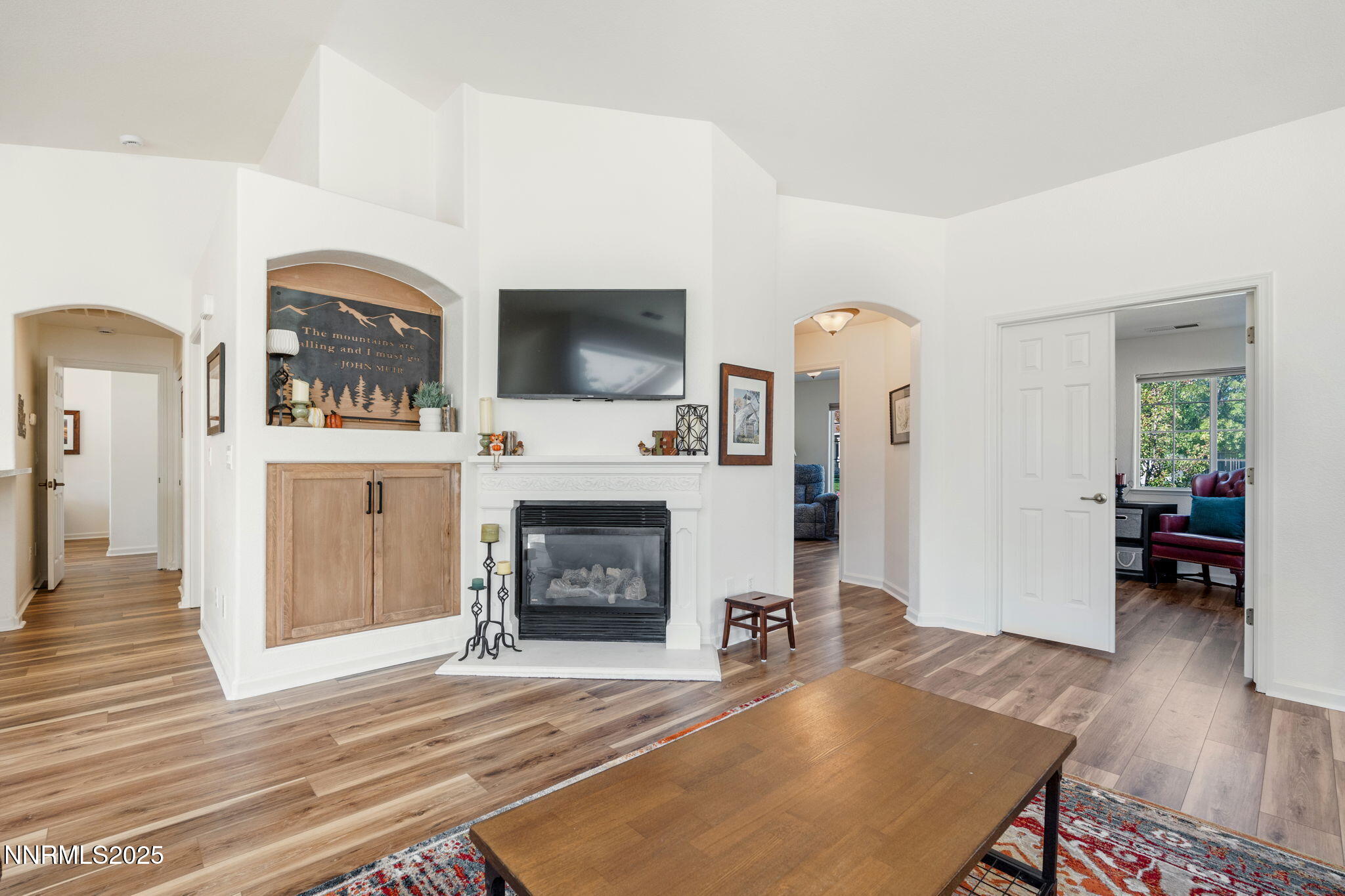 10320 Rosemount Drive Reno, NV 89521 - Photo 6 of 27 a living room with furniture a fireplace and a flat screen tv