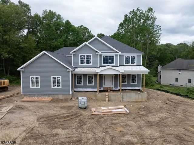 a front view of a house with a yard and trees