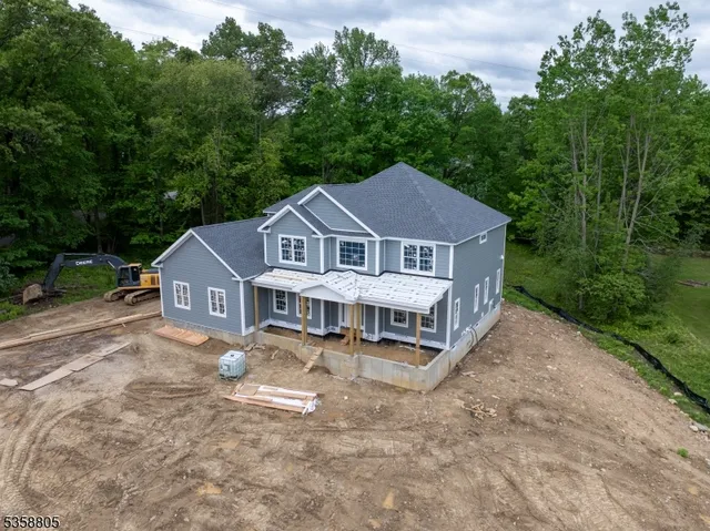 a view of a house with pool and a yard