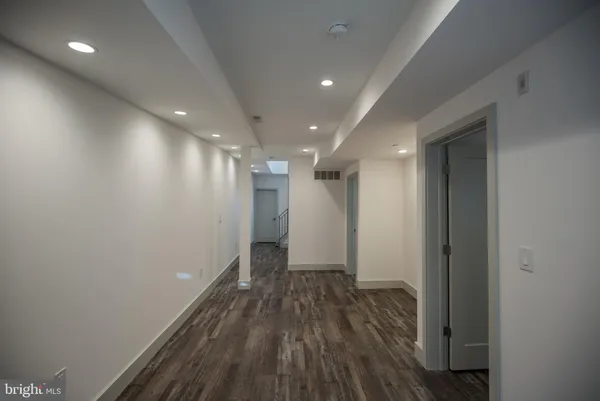 a view of hallway with wooden floor