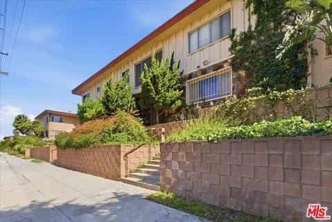 a view of a building with potted plants