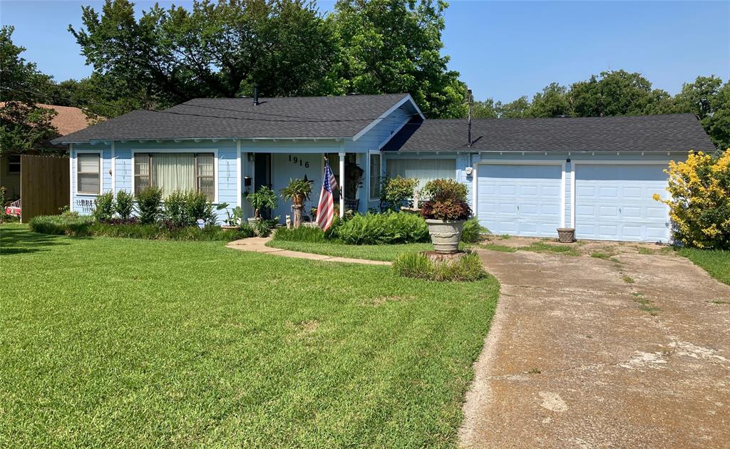 1916 Tierney Road Fort Worth, TX 76112 - Photo 1 of 12 Ranch-style house featuring a garage, a shingled roof, a front yard, and concrete driveway