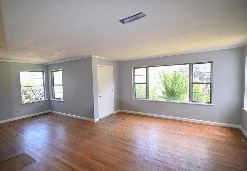 1916 Tierney Road Fort Worth, TX 76112 - Photo 5 of 12 Unfurnished room featuring crown molding and wood-type flooring
