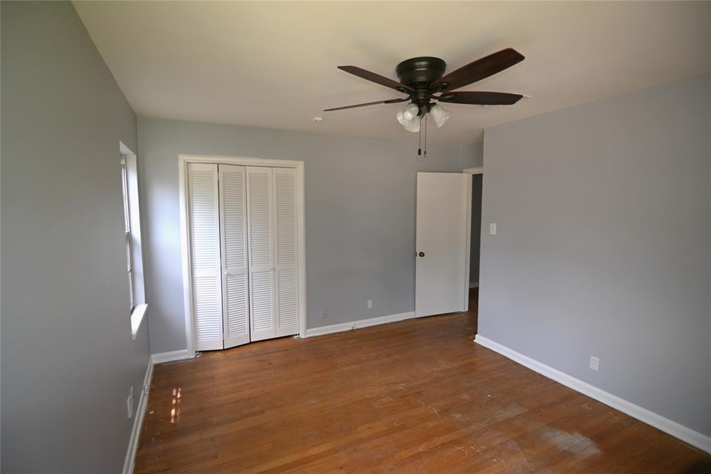 1916 Tierney Road Fort Worth, TX 76112 - Photo 6 of 12 Unfurnished bedroom with wood finished floors, a closet, and ceiling fan