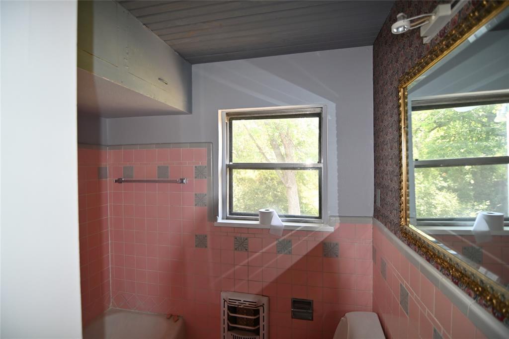 1916 Tierney Road Fort Worth, TX 76112 - Photo 10 of 12 Bathroom featuring wainscoting, tile walls, and heating unit