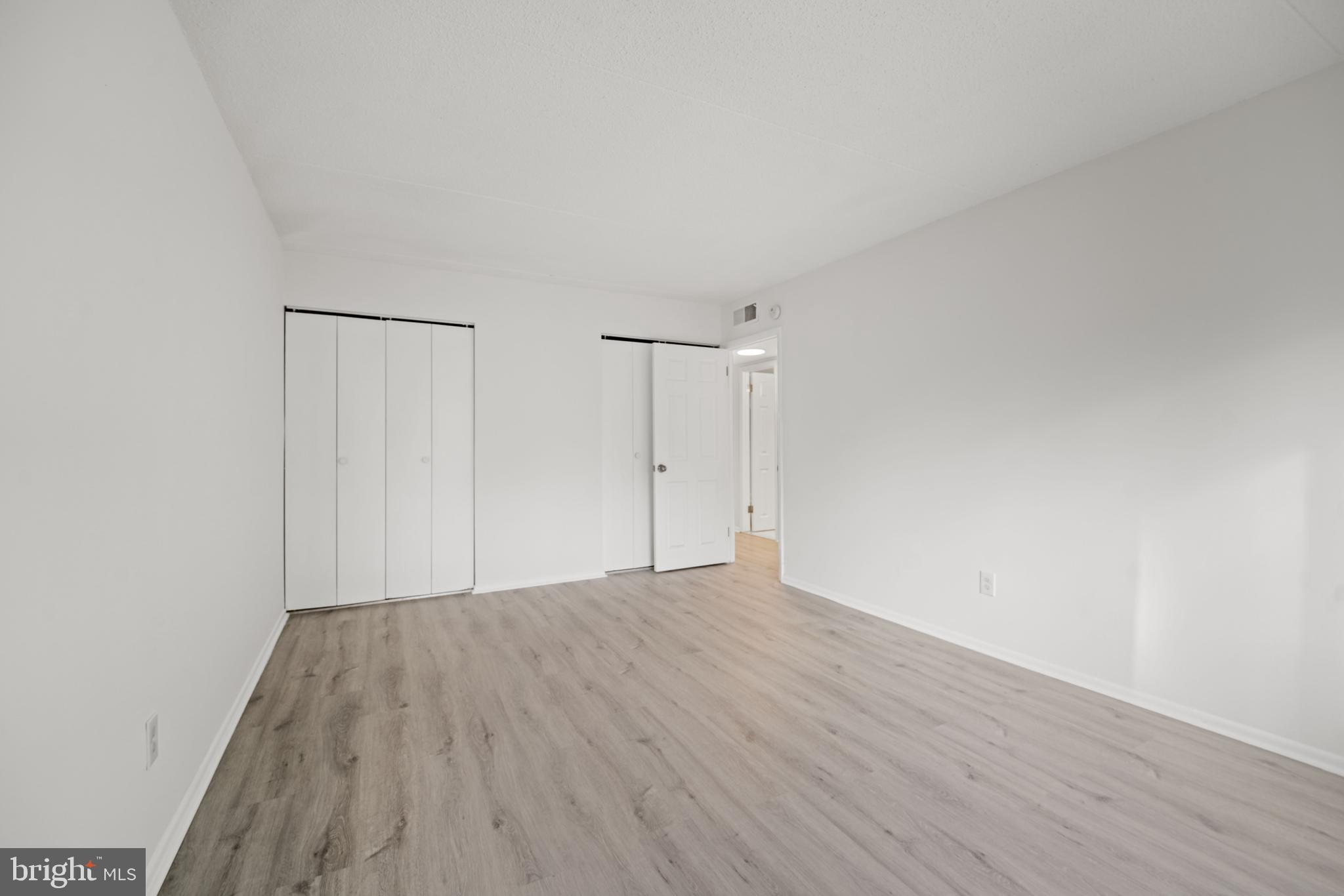 856 Putnam Boulevard, Unit 67A Wallingford, PA 19086 - Photo 14 of 26 a view of an empty room with wooden floor