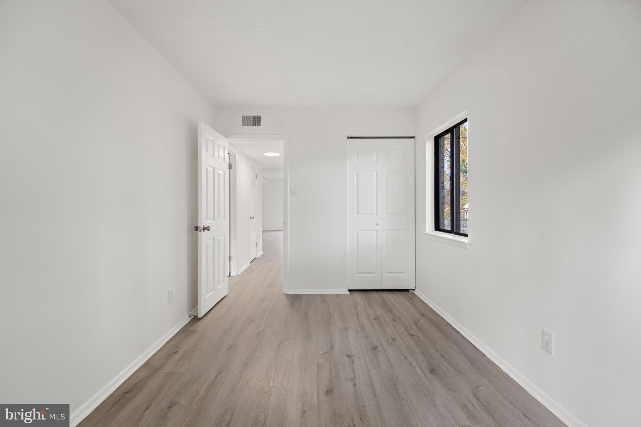856 Putnam Boulevard, Unit 67A Wallingford, PA 19086 - Photo 16 of 26 a view of a hallway with wooden floor