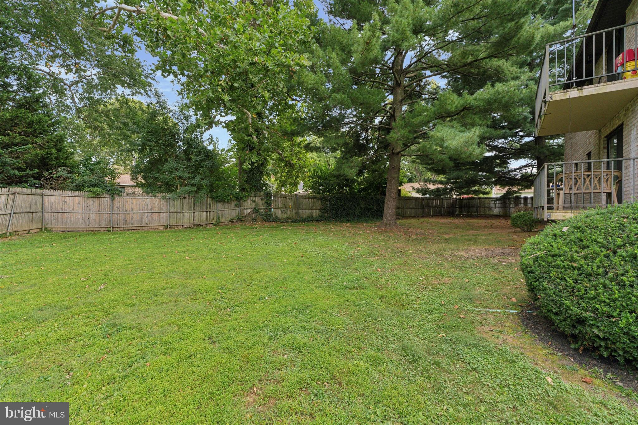 856 Putnam Boulevard, Unit 67A Wallingford, PA 19086 - Photo 17 of 26 a view of a yard with a house in the background