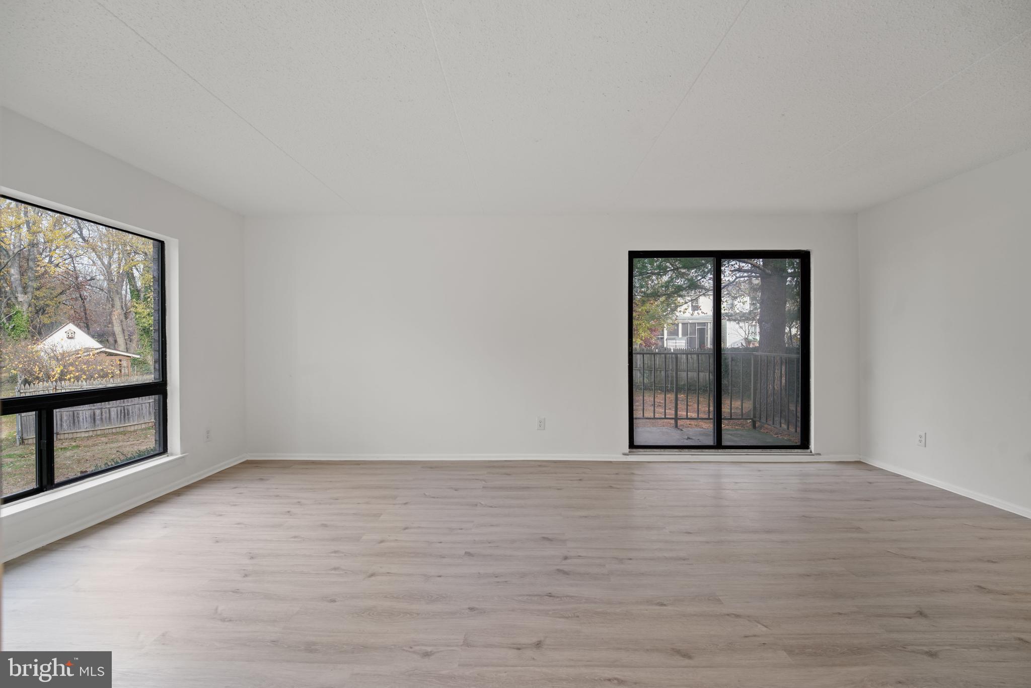 856 Putnam Boulevard, Unit 67A Wallingford, PA 19086 - Photo 3 of 26 a view of an empty room with wooden floor and fireplace