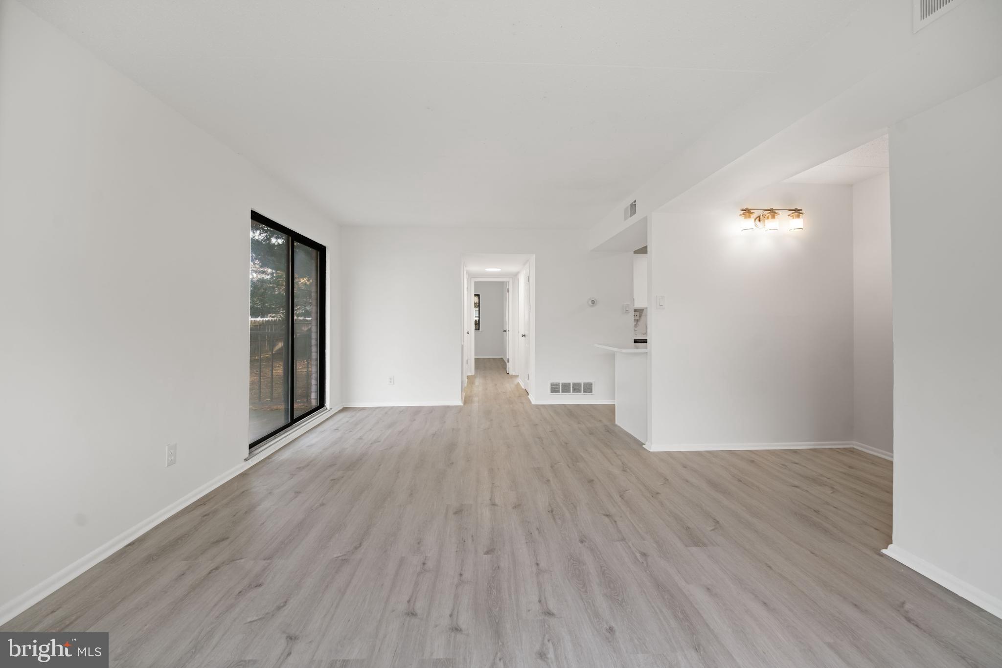 856 Putnam Boulevard, Unit 67A Wallingford, PA 19086 - Photo 5 of 26 a view of empty room with wooden floor