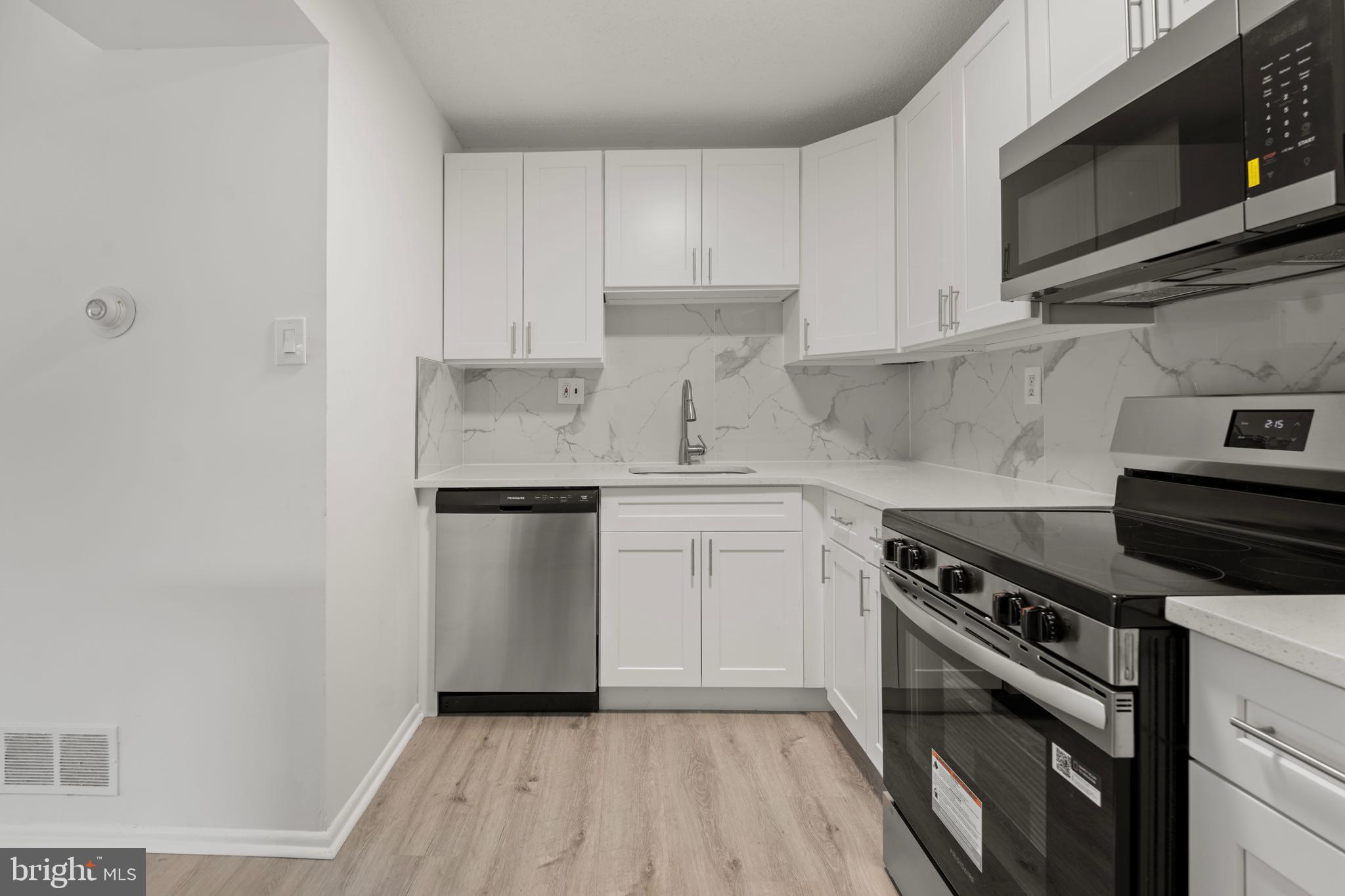 856 Putnam Boulevard, Unit 67A Wallingford, PA 19086 - Photo 8 of 26 a kitchen with a stove microwave and sink