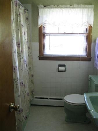 155 Brittany Road Springfield, MA 01151 - Photo 8 of 14 a bathroom with a toilet a sink and a window