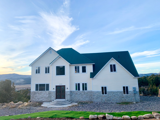 12645 East Cedar Ridge Drive Fairview, UT 84629 - Photo 2 of 25 View of front of property with a mountain view, stone siding, and a metal roof