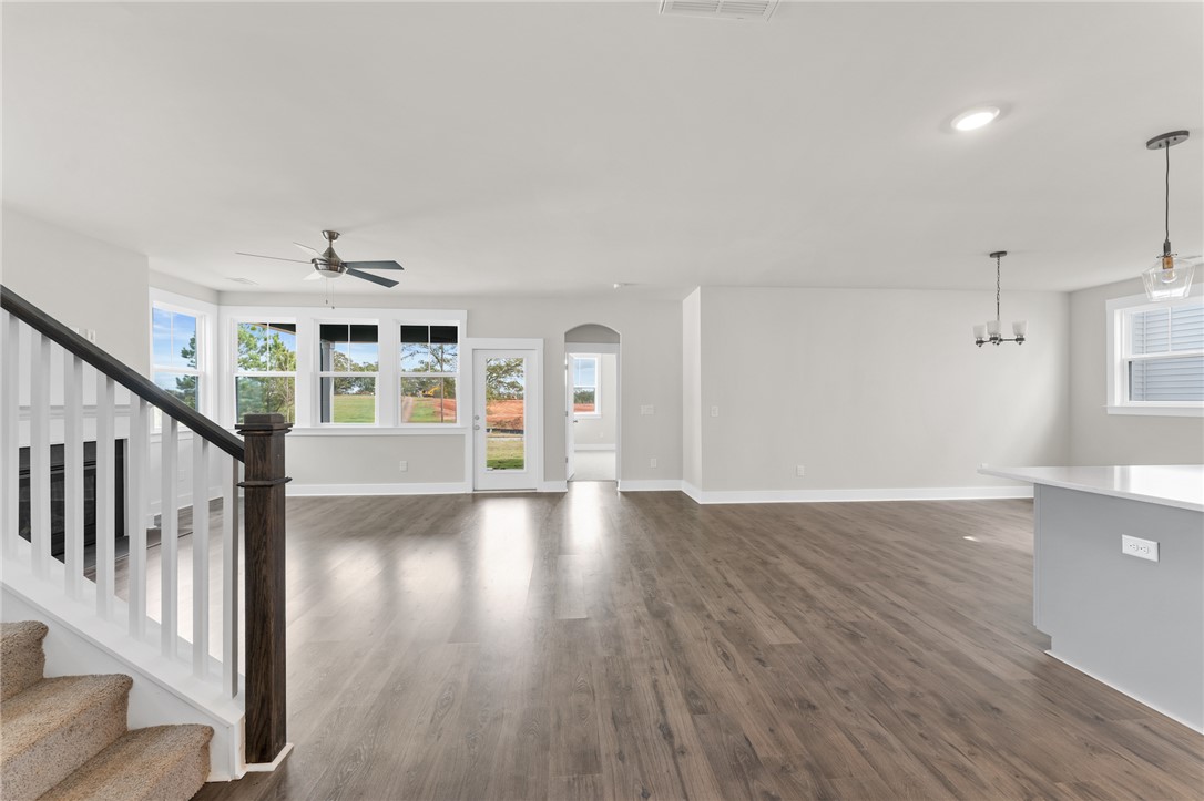 167 Tiger Lily Drive Anderson, SC 29621 - Photo 9 of 34 Flowing hardwood-style flooring and an abundance of windows create an inviting, sun-drenched living space.
