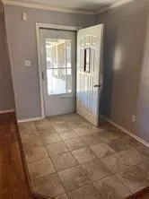 an empty room with a empty space and windows