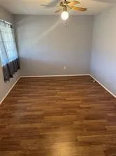 a view of a room with an empty space and a window