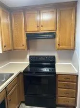 a stove top oven sitting inside of a kitchen