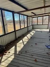 a view of a balcony with wooden floor