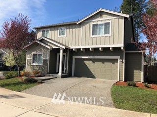 3032 Eagle Loop Northeast Lacey, WA 98516 - Photo 2 of 23 a front view of a house with a garden