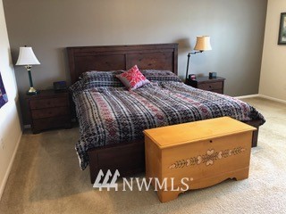 3032 Eagle Loop Northeast Lacey, WA 98516 - Photo 11 of 23 a bedroom with a bed and a lamp