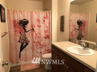 3032 Eagle Loop Northeast Lacey, WA 98516 - Photo 18 of 23 a bathroom with a granite countertop sink and a mirror