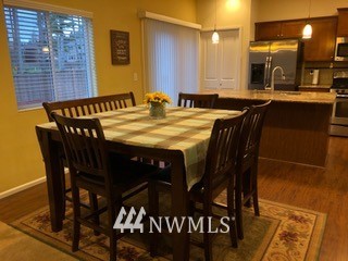 3032 Eagle Loop Northeast Lacey, WA 98516 - Photo 5 of 23 a dining room with a wooden table and chairs