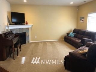 3032 Eagle Loop Northeast Lacey, WA 98516 - Photo 8 of 23 a living room with furniture and a flat screen tv
