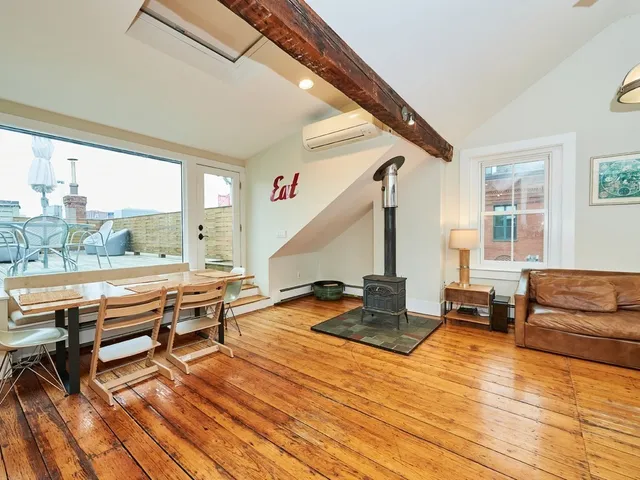 a living room with furniture a table and wooden floor