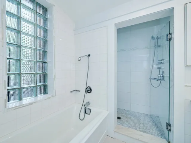 a bathroom with a shower sink and mirror
