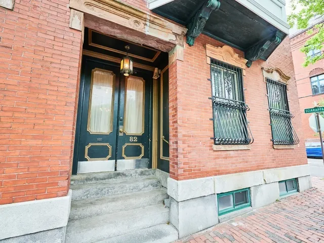 a view of a brick house with a large windows