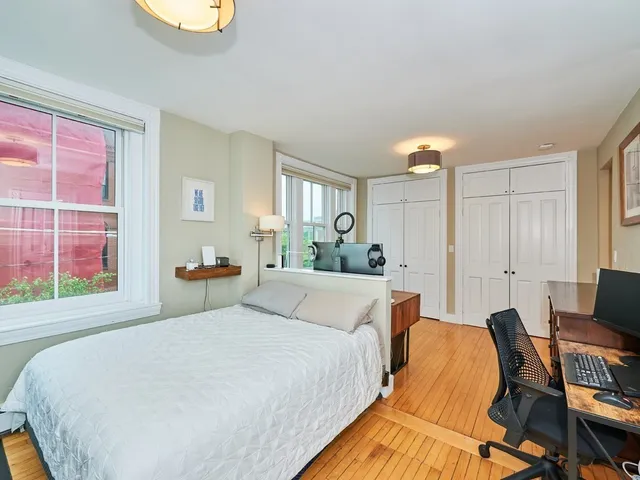 a bed room with a bed and a chair