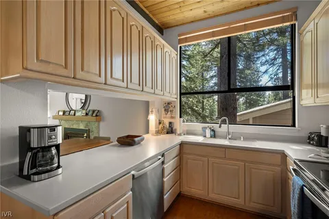 a kitchen with stainless steel appliances granite countertop a sink a stove and cabinets