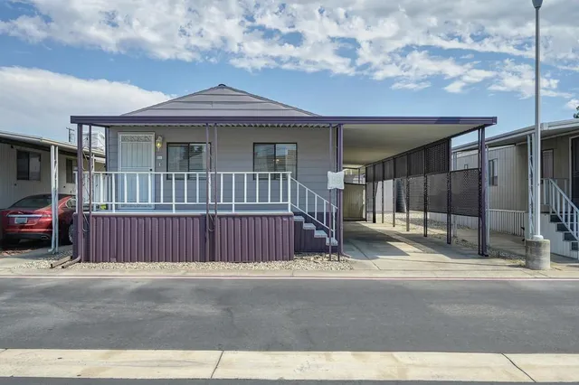 a view of a house with a wooden fence