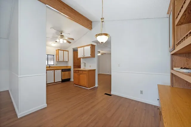a view of a room with wooden floor closet and windows
