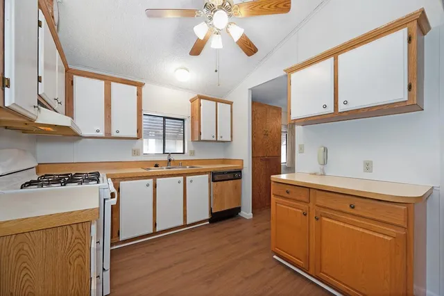 a kitchen with stainless steel appliances granite countertop a stove and a refrigerator