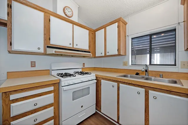 a kitchen with a cabinets and wooden floor