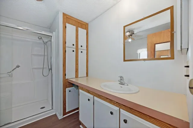 a utility room with cabinets and wooden floor