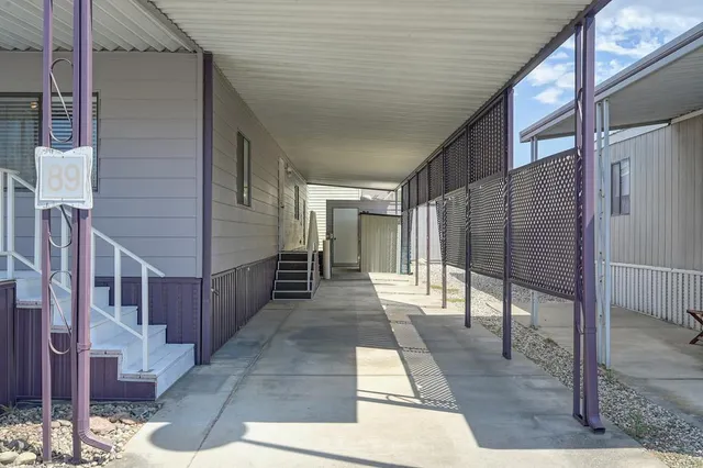 a outdoor patio with swimming pool table and chairs