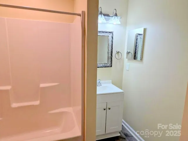 a bathroom with a shower and a sink
