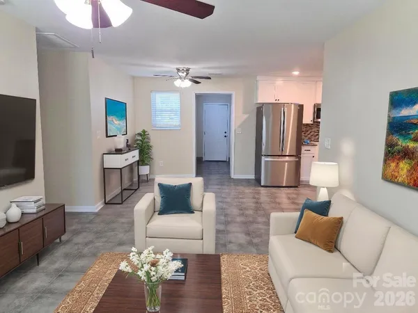 a living room with furniture and a flat screen tv