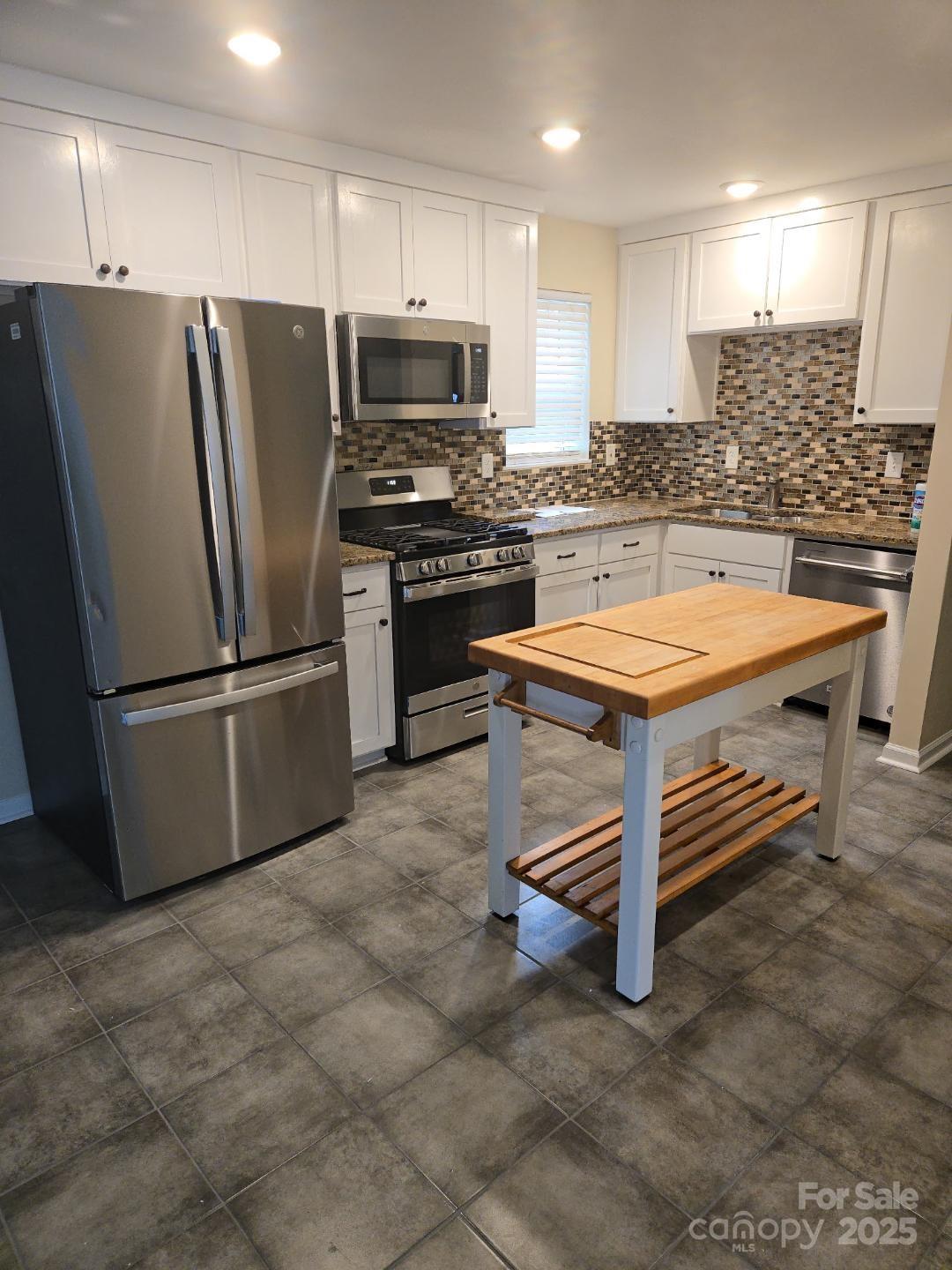 1352 Steed Street Rock Hill, SC 29732 - Photo 4 of 15 a kitchen with stainless steel appliances a refrigerator a stove a sink and a refrigerator
