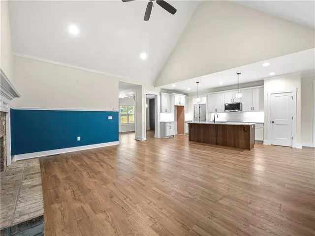 a view of kitchen and hall with wooden floor