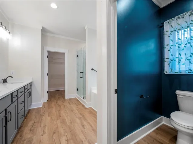 a bathroom with a granite countertop toilet sink and shower