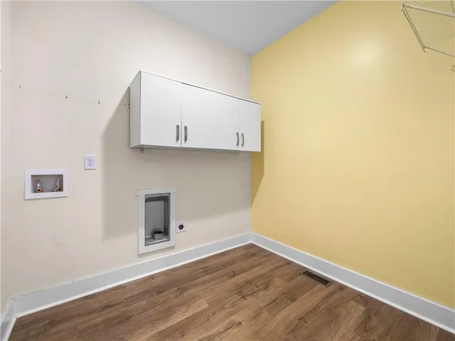 a room with a wooden floor and a window