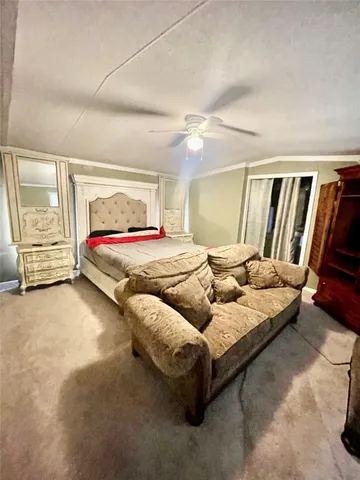 a bedroom with a bed couch and window
