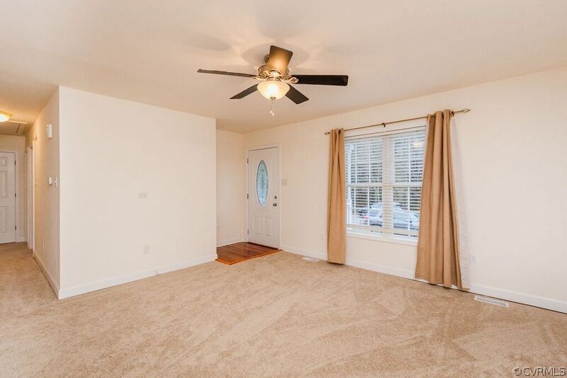 6037 Springbank Road Petersburg, VA 23803 - Photo 3 of 15 a view of empty room with wooden floor and fan