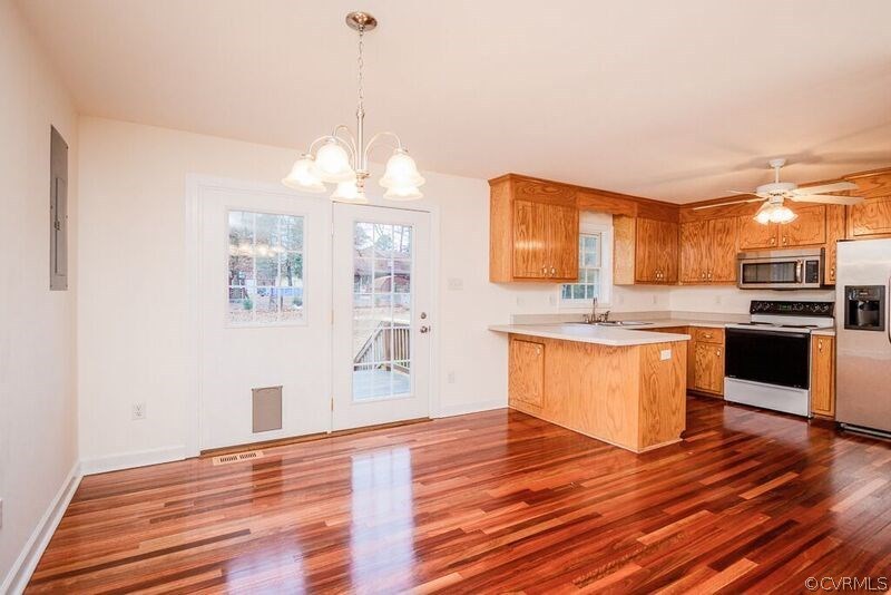 6037 Springbank Road Petersburg, VA 23803 - Photo 5 of 15 a kitchen with stainless steel appliances granite countertop a stove a sink and a wooden floors