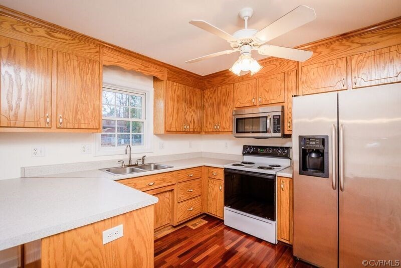 6037 Springbank Road Petersburg, VA 23803 - Photo 6 of 15 a kitchen with a sink stainless steel appliances a sink and cabinets