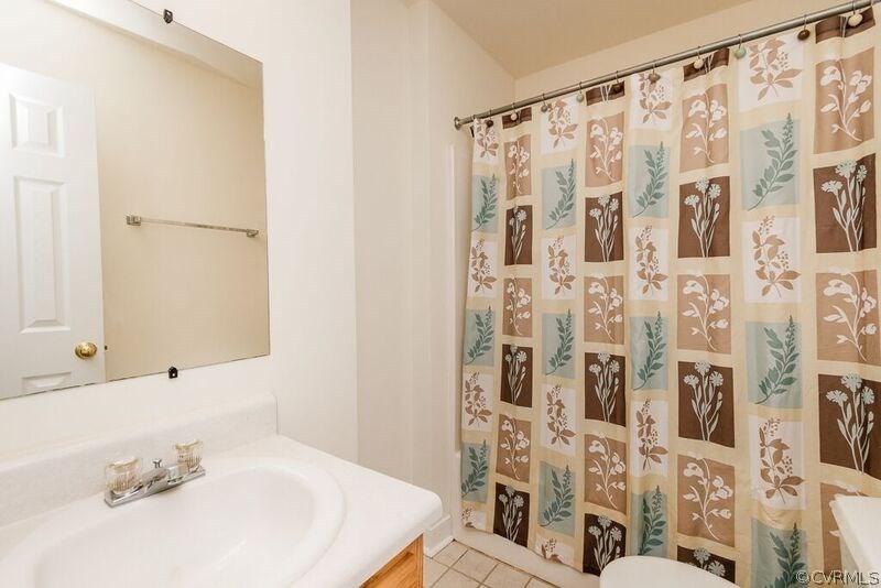 6037 Springbank Road Petersburg, VA 23803 - Photo 7 of 15 a bathroom with a sink and a mirror